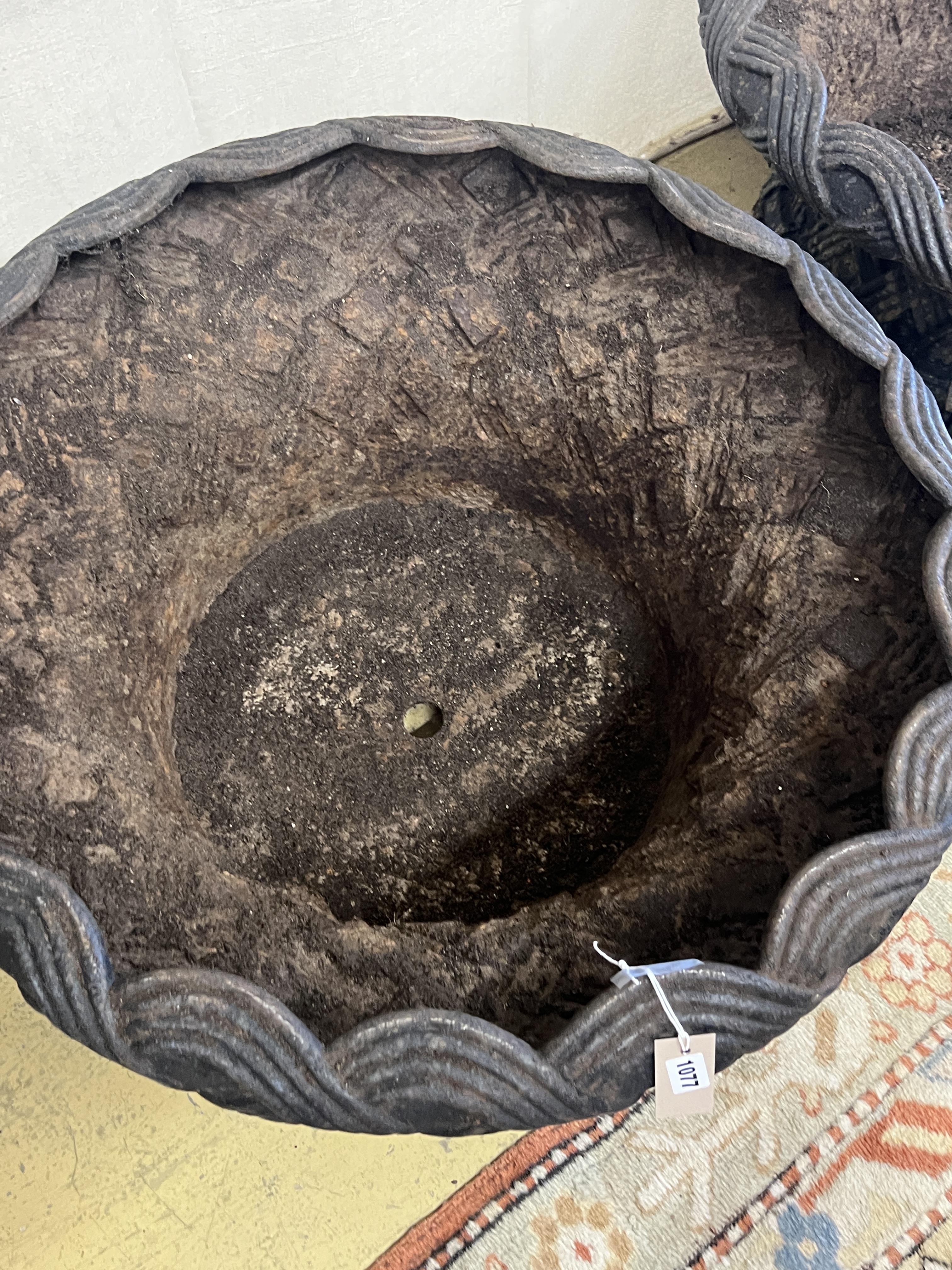 A large pair of circular weathered cast iron planters, diameter 82cm, height 43cm